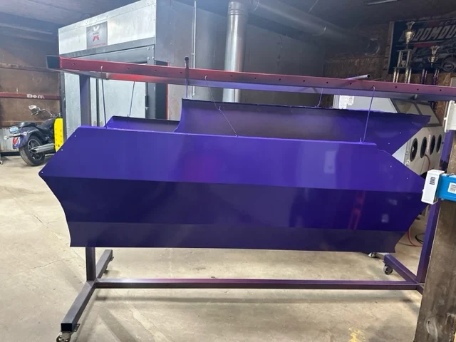 Plow blade stripped of rust and coated candy purple